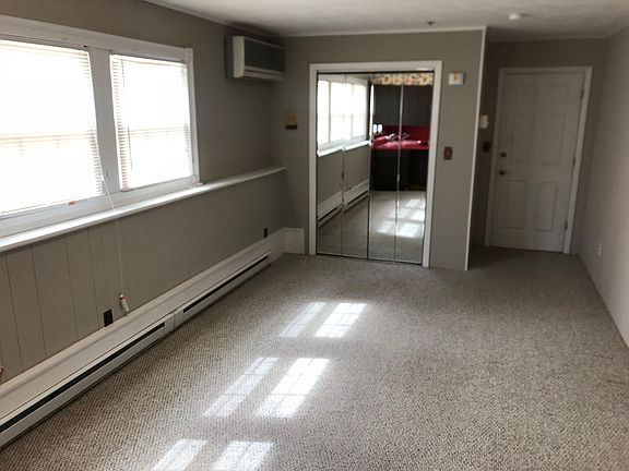 Living room with large storage closet and built in AC