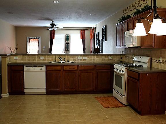 The kitchen features Corian counter tops, tile floors and an electric range.