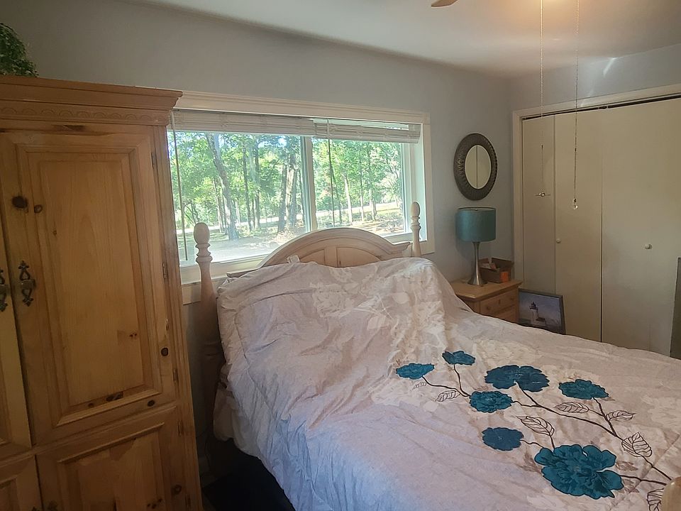 Bedroom w/ queen bed, wardrobe, and large closet.
