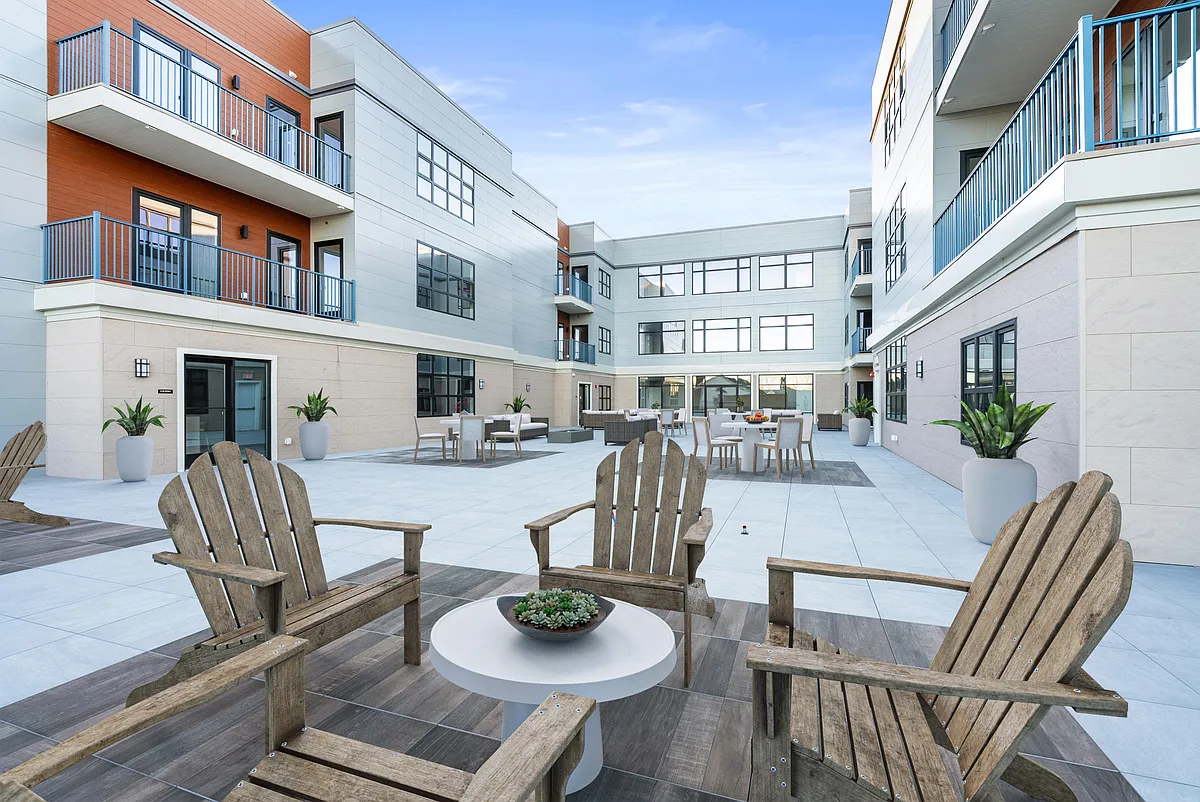 Adjacent to the community room where you can entertain your guests, the furnished courtyard features BBQ grills, firepit and seating arrangements for your outdoor enjoyment! - The View at Long Branch