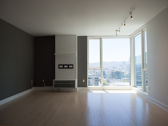 Living area with installed TV mount and media cabinet