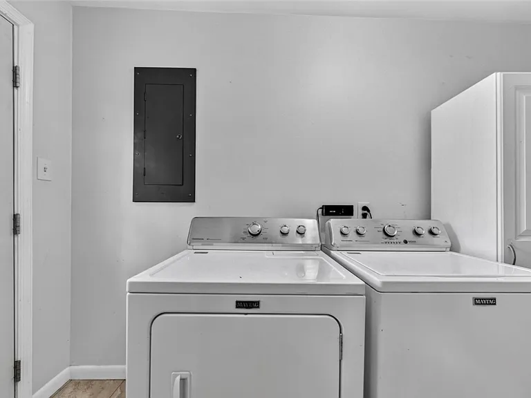 Washer and dryer in hallway off kitchen to the back door