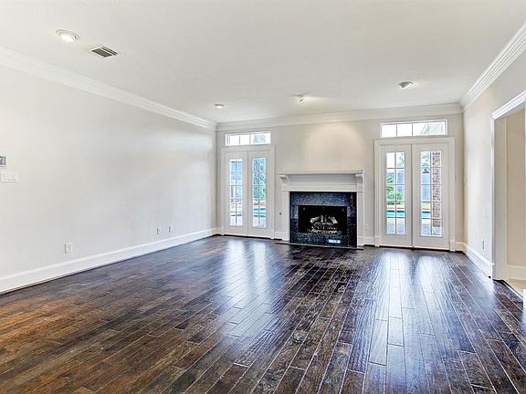 The Family room is anchored with a fireplace and views of your private pool. There is also a convenient wet bar on the wall oppo