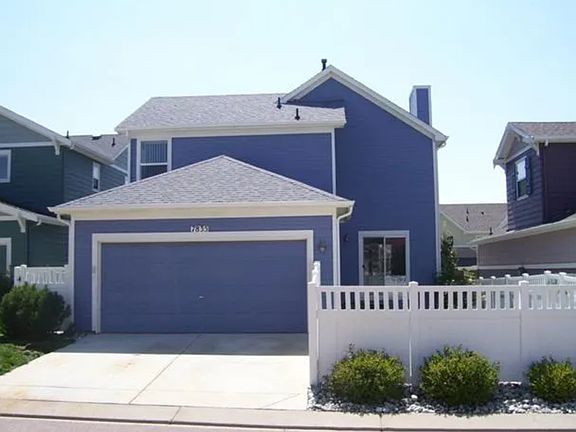 Garage and small fenced in backyard