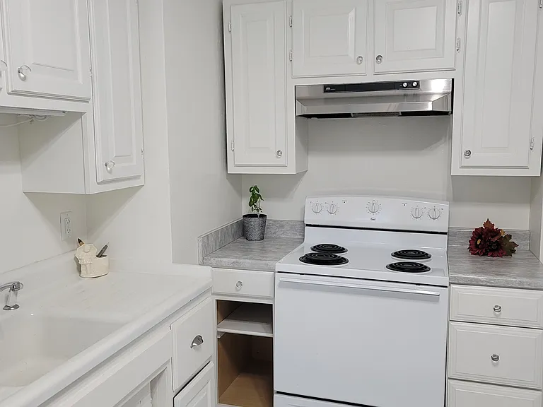 Farmhouse Kitchen. Electric Stove. Not shown portable Dishwasher.