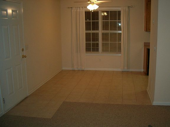Tile flooring in the dining room, there is also a bar.
