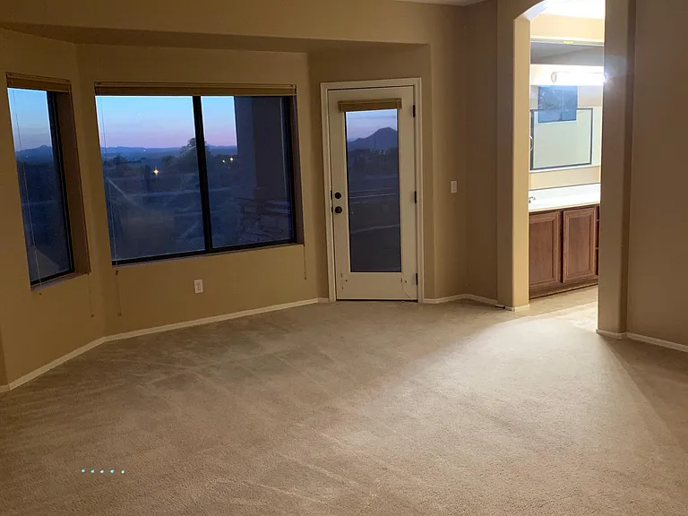 Large master bedroom and door to covered balcony