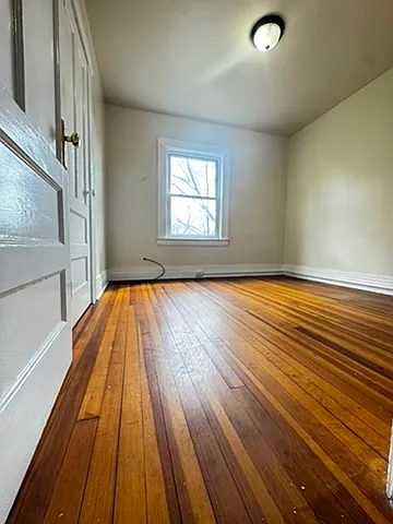Spacious, quiet bedroom overlooking the backyard, featuring a large window that brings in abundant natural light and fresh air. Includes a convenient walk-in closet, making it both comfortable and highly functional for everyday living.