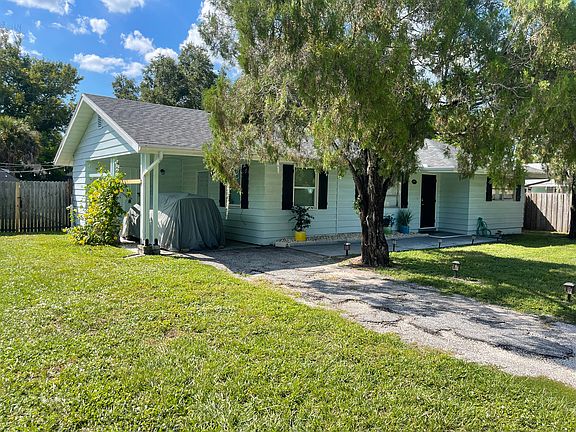 Home features a Carport with Storage Room.