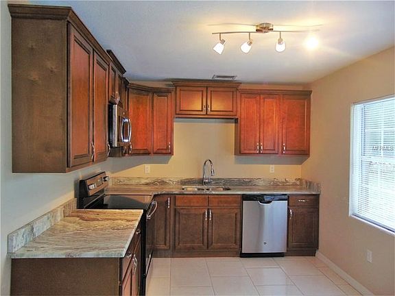 Remodeled Kitchen with granite counter tops and wood cabinets