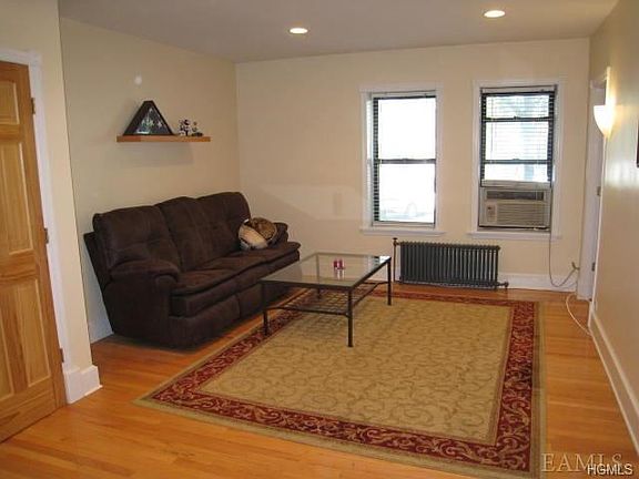 Open Living Room with hardwood floors. Room is 18' x 13' plus kitchen that is 11'- x 7'
