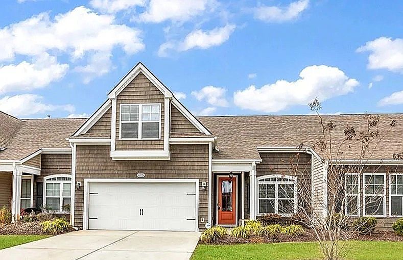 Front of the house with a 2 car garage and a 4 car driveway