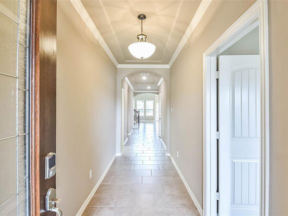 Inviting with handsome ceiling detail and convenient keyless entry. Notice the door on the right, this is the entrance to main house from the private mother in law suite.
