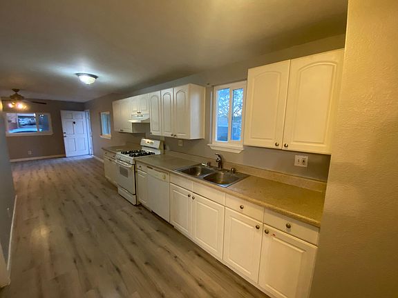 Galley style kitchen with 16 cabinets and 5 drawers.