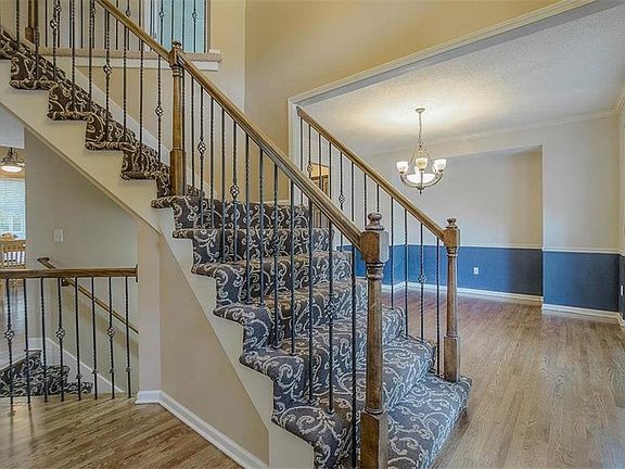 Gleaming NEWLY refinished hardwood floors greet you!