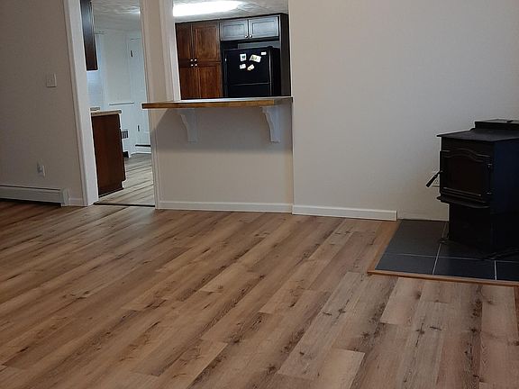 Dining room looking into kitchen (wood pellet stove included for optional secondary heating source)