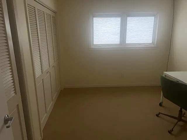 Bed room 1 faces the street. One wall is storage space.