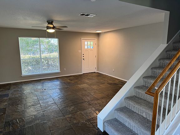 Large spacious living room with new lighting, fans and completely repainted.