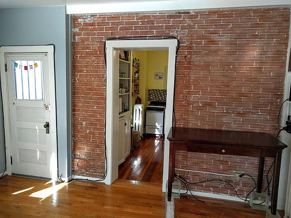 EXPOSED BRICK ! DOOR TO THE LEFT LEADS TO A PRIVATE DECK