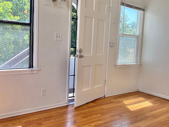 Living room to front door from kitchen.