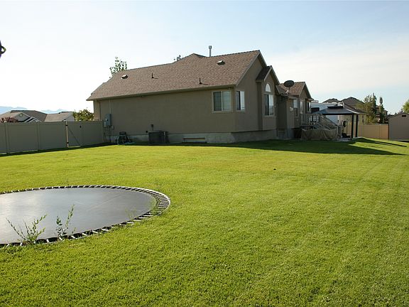 in groung trampoline and large fenced in back yard