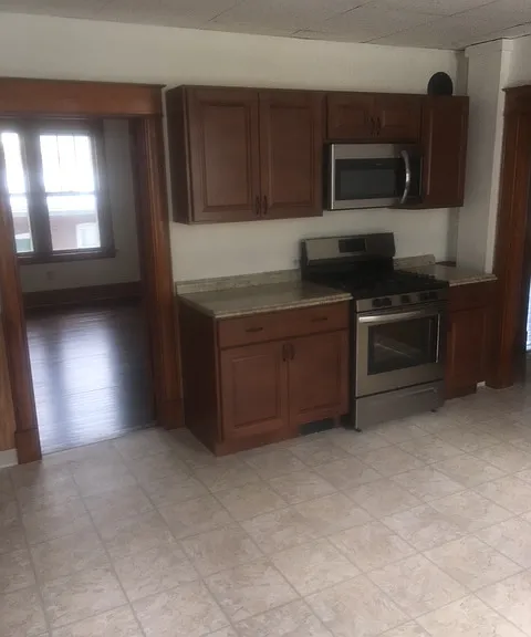 Kitchen with gas stove and microwave