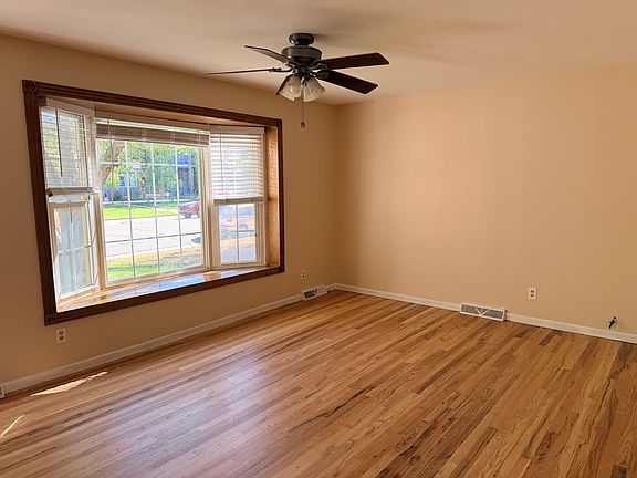 Freshly painted living room with newly refinished gleaming oak floors.
