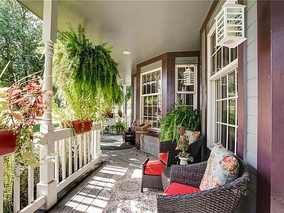 Wrap around front porch is so welcoming, you'll never want to leave this little seclusion of bliss!