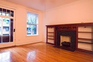 Huge Living room with mantel and fireplace, leads to balcony
