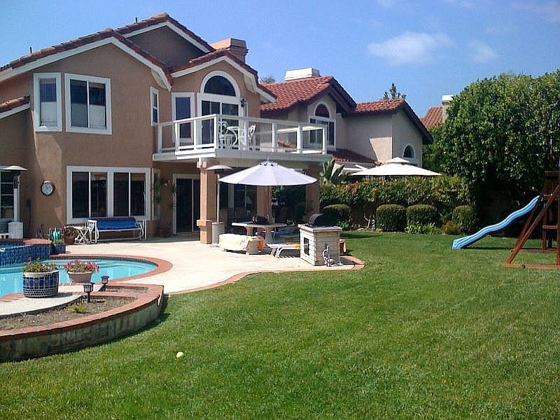 lot 10,500 sq foot includes pool, grass, entertainment area tables swing