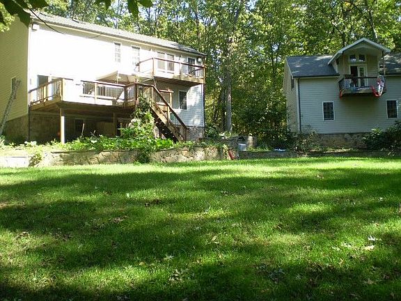 Back yard with house (L) and garage (R)