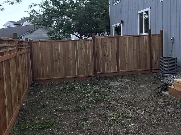 Backyard is fenced with low maintenence bark.