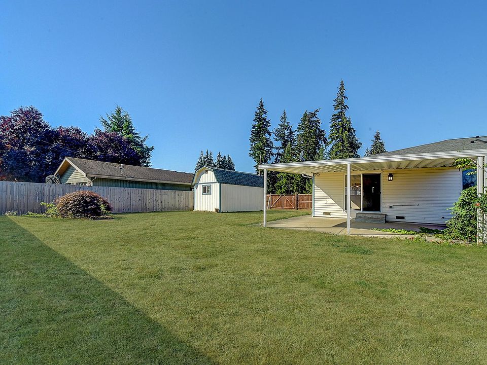 Back Yard and rear view of the house with shed on a side