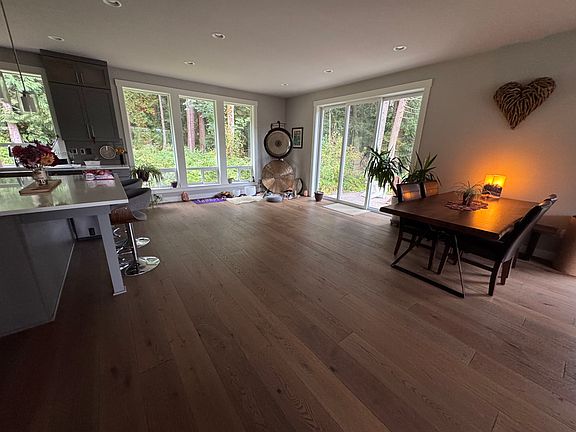 View of open-space kitchen, living room and dining area.