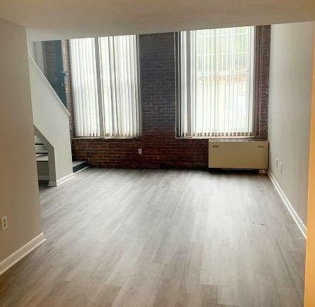 Huge windows, brick walls.