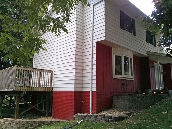 The front and east side of the house, with the bay window and deck.