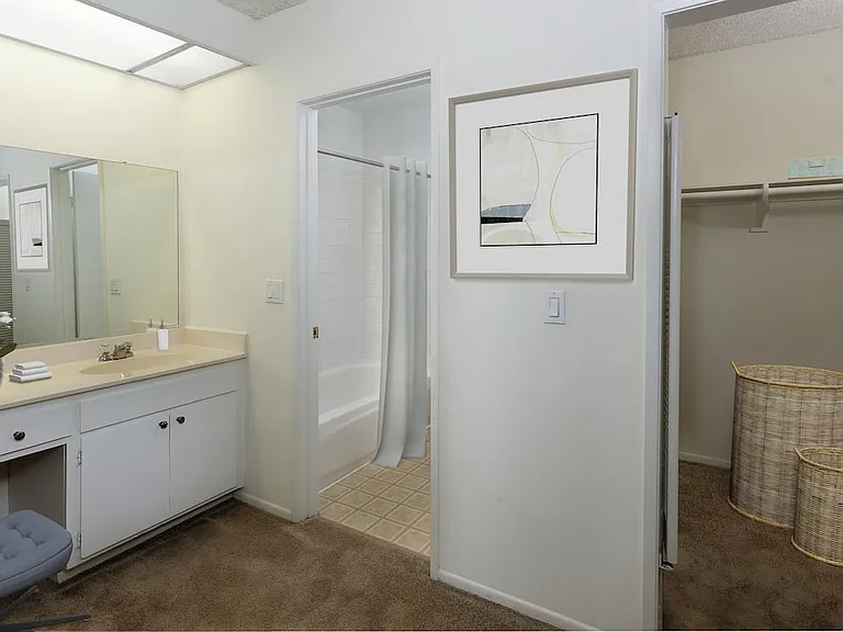 Classic bath with white cabinetry and tile flooring