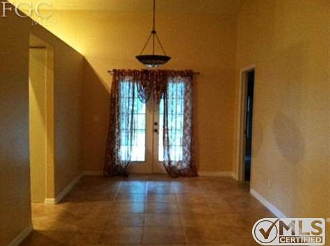 Dining Area with French Doors leading out to the Pool Area.