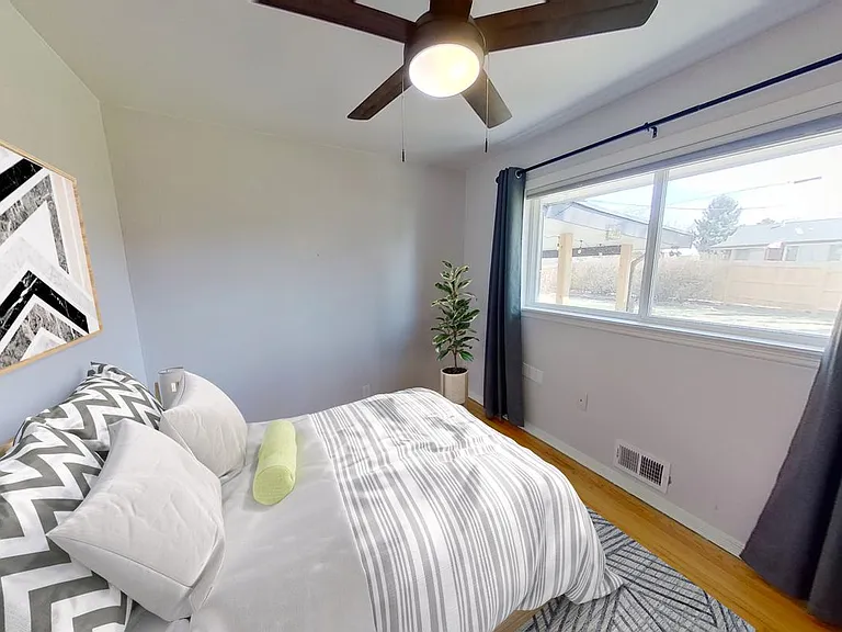 Bedroom 2 w/access to private bath. This image shows a virtually furnished space. Bedrooms come unfurnished.