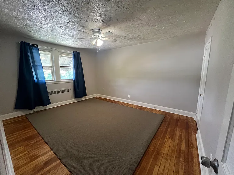 Large bedroom with hardwood floors and big windows and closet - rented