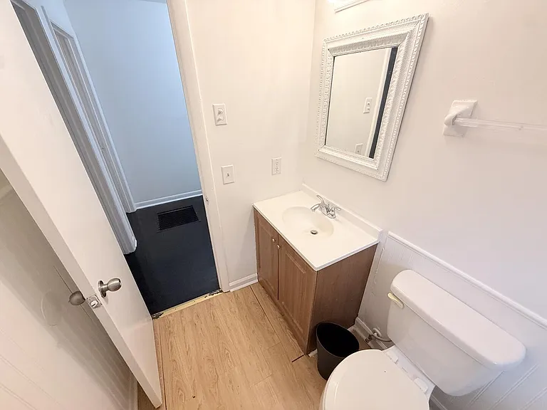 Bathroom with a single-sink vanity, framed mirror, and easy-care flooring for everyday convenience.