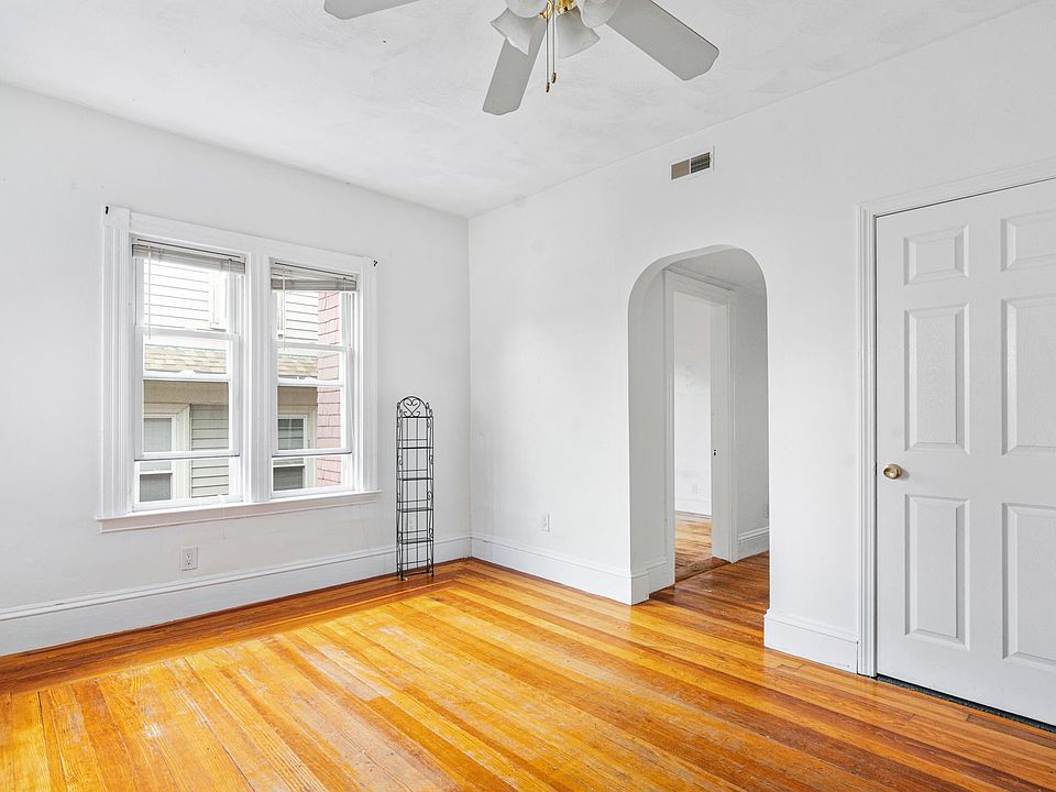 Spacious living room with tall windows (ample natural light), 12Ft High Ceilings and beautiful new polished hardwood floors