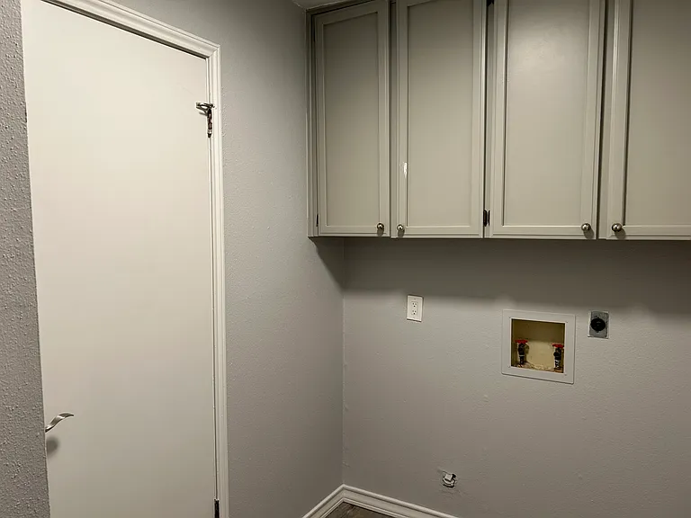 Laundry room and storage cabinets.