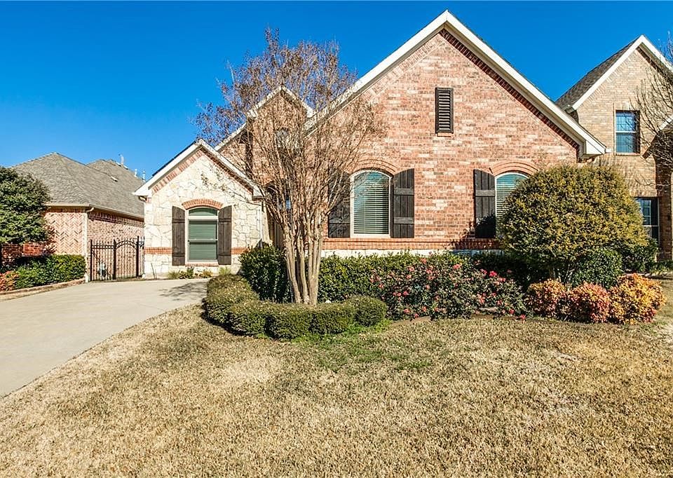 Curb appeal plus, beautifully landscaped and a gorgeous stone and brick exterior