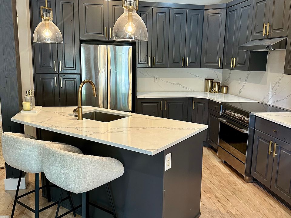Kitchen w/marble counters, Fisher Paykel appliances, West elm cabinet pulls, Restoration Hardware lighting, Cb2 barstools, refinished hardwood floors