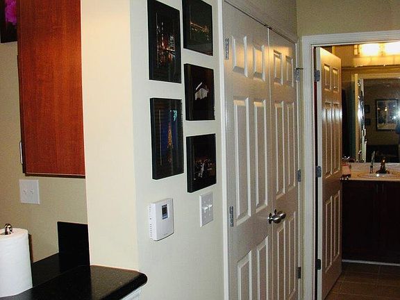 Washer/dryer closet on left with bathroom door at end of hall.