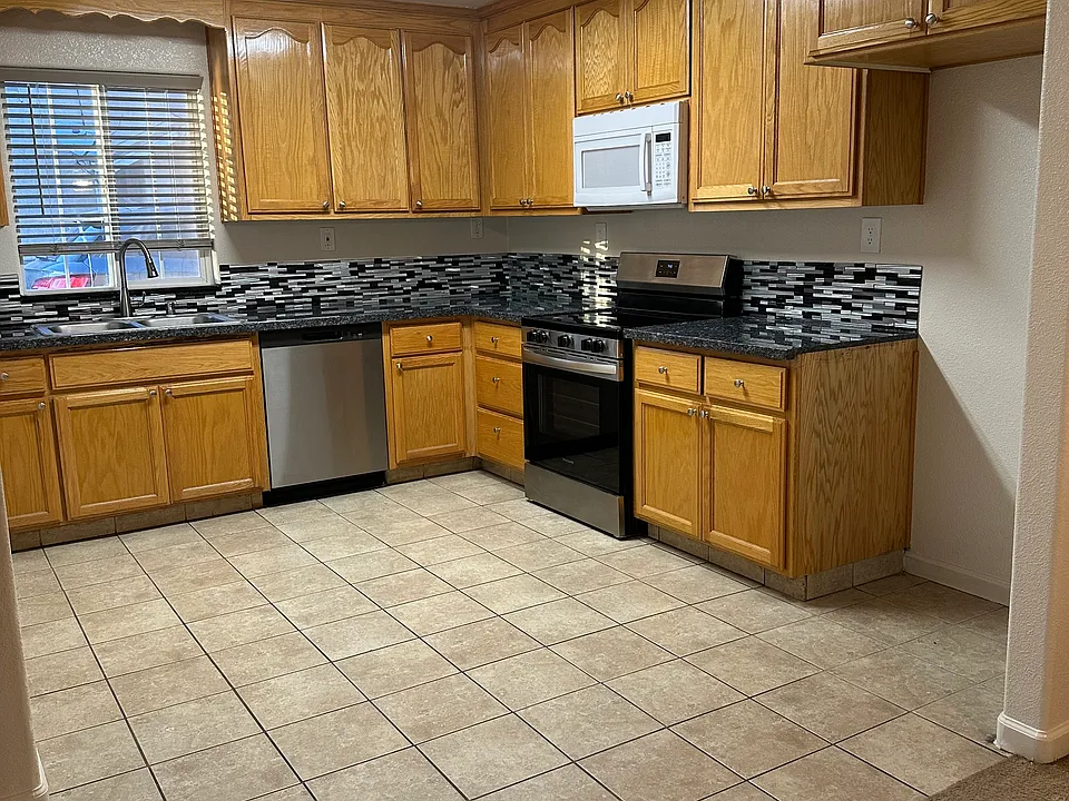 Kitchen with new granite countertops, new dishwasher, and new stove