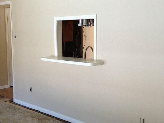 Living room and kitchen are connected by pass-through window.