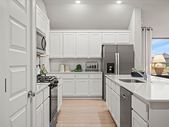 Kitchen in the Diamond home plan by Trophy Signature Homes - REPRESENTATIVE PHOTO