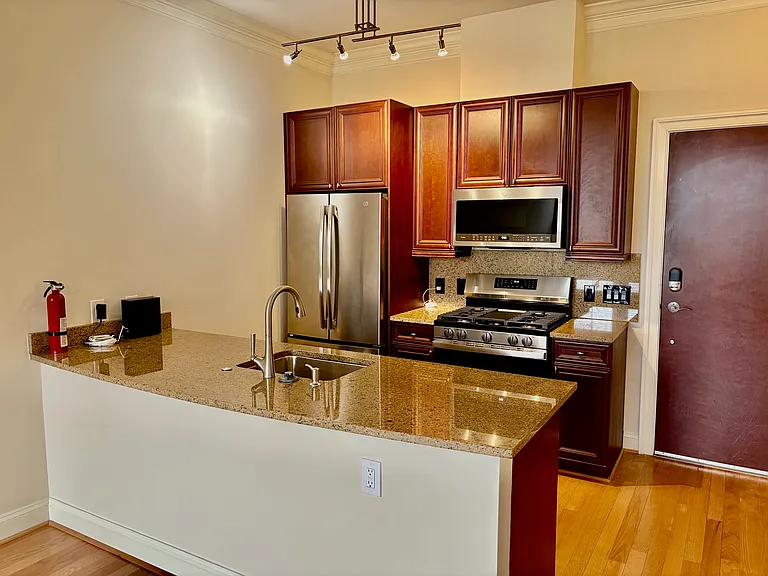 Kitchen w/ Granite Countertops, Cherry Cabinets and Bran New Stainless Steel Appliances.